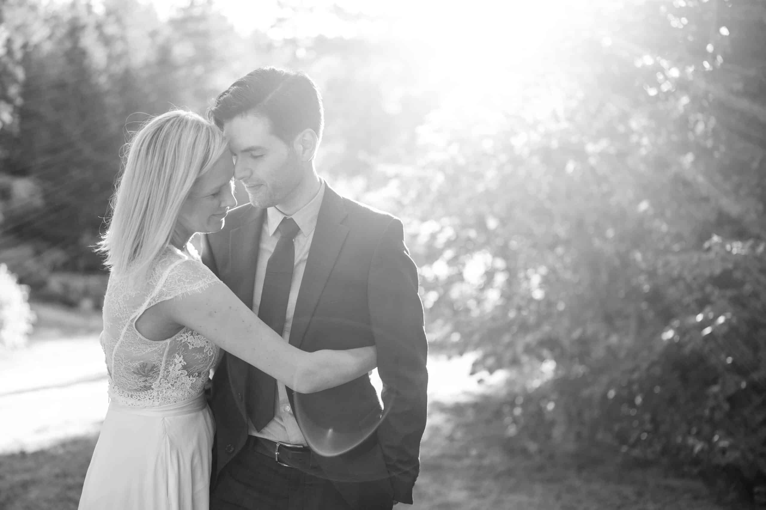 Couple embracing in sunlight.