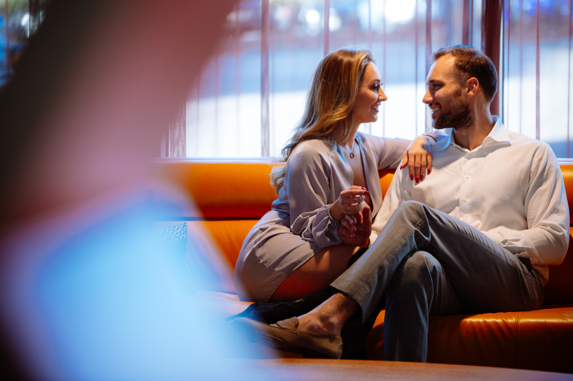 Two photos of people dancing and laughing at a party; the left shows a woman in a red dress and a man posing energetically, while the right shows two women smiling and embracing amid a lively crowd. Jessica Hill Photography - Wedding Photographer - Oregon