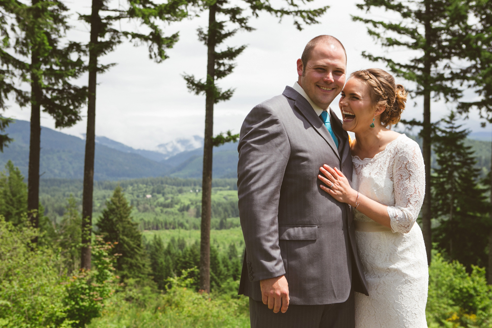 A couple dressed formally kiss outdoors at dusk while holding lit sparklers, with trees in the background. Jessica Hill Photography - Wedding Photographer - Oregon