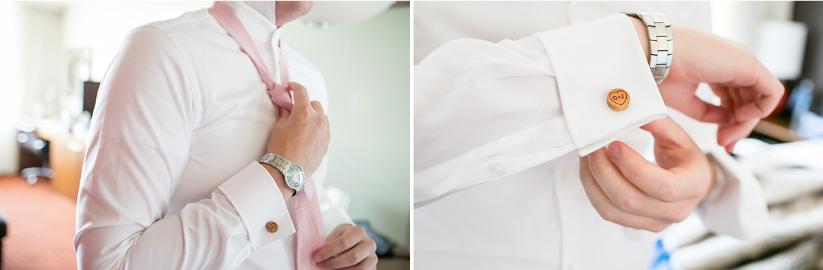 A man wearing a white dress shirt adjusts a light pink tie and fastens a cufflink engraved with "GW" on his shirt sleeve. He is also wearing a silver wristwatch. Jessica Hill Photography - Wedding Photographer - Oregon