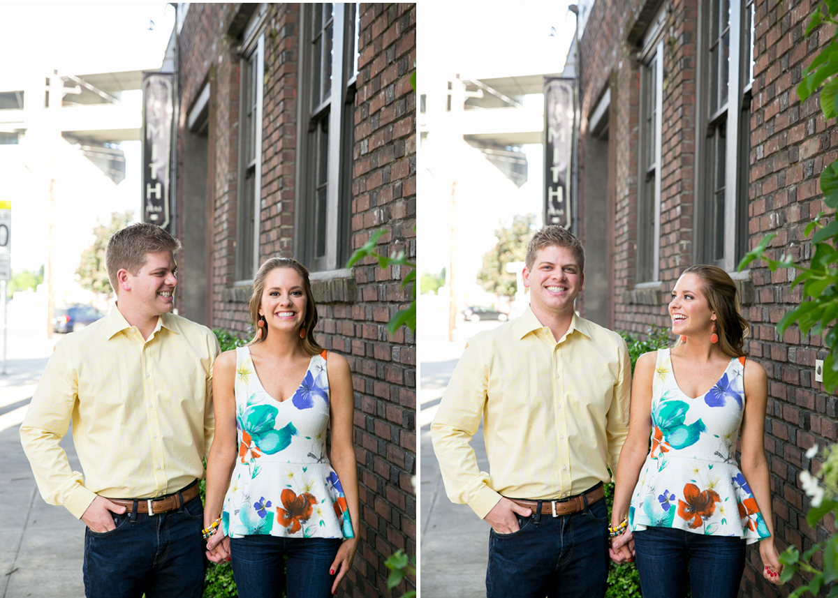 A man and woman stand and hold hands on a sidewalk next to a brick building, smiling and looking at each other. Jessica Hill Photography - Wedding Photographer - Oregon