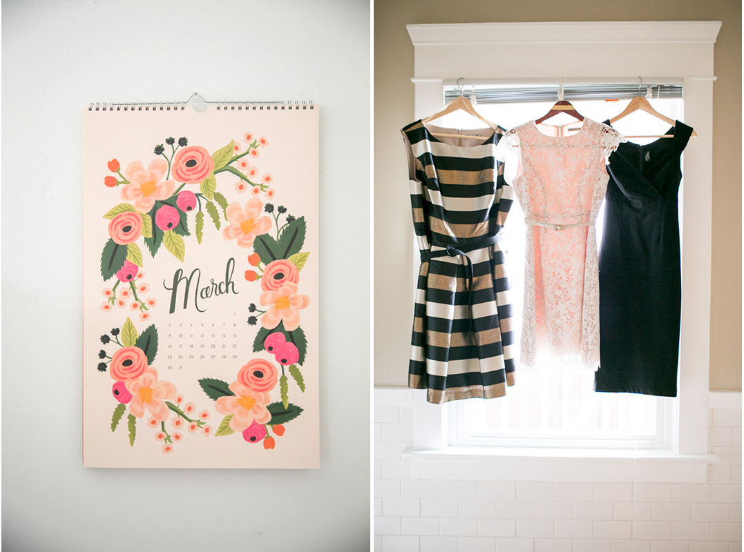A floral March calendar hangs on a wall next to three dresses—striped, lace, and black—displayed on hangers in a window. Jessica Hill Photography - Wedding Photographer - Oregon