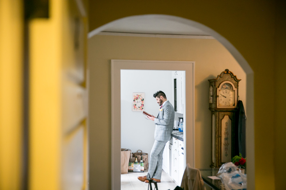 A woman in a white dress rests her head on the shoulder of a man in a suit; both appear tired and have their eyes closed at a table set with drinks and plates. Jessica Hill Photography - Wedding Photographer - Oregon