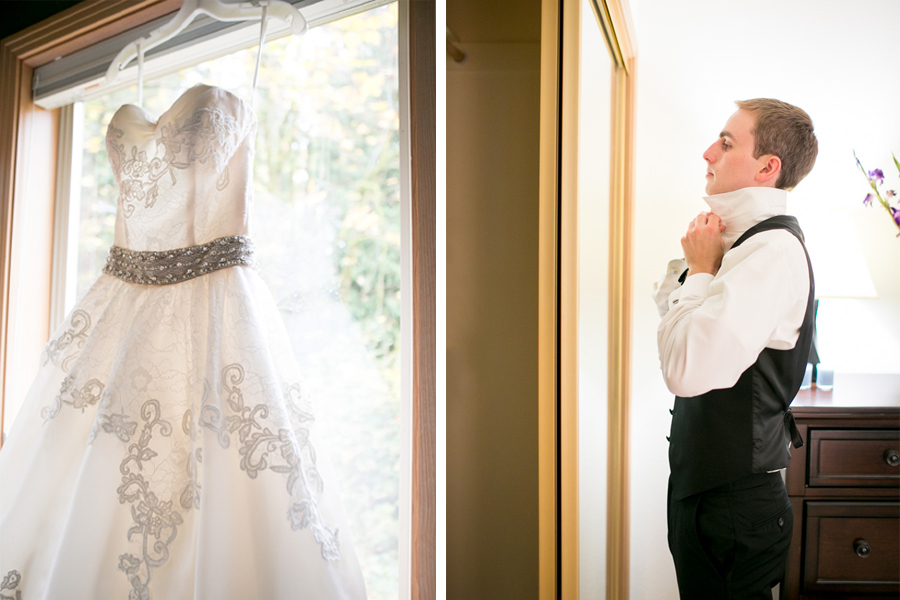 A white wedding dress hangs on a window; beside it, a man in formal attire adjusts his collar in front of a mirror. Jessica Hill Photography - Wedding Photographer - Oregon