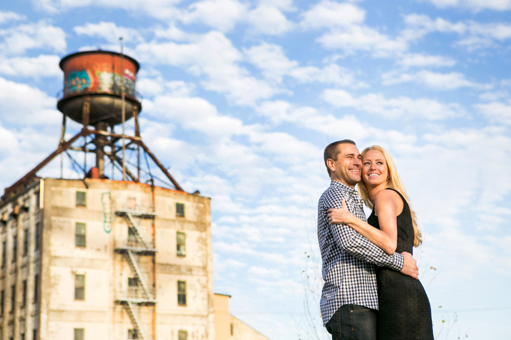 A man in a suit and a woman in a wedding dress smile and hold up a marriage certificate inside a building. Jessica Hill Photography - Wedding Photographer - Oregon