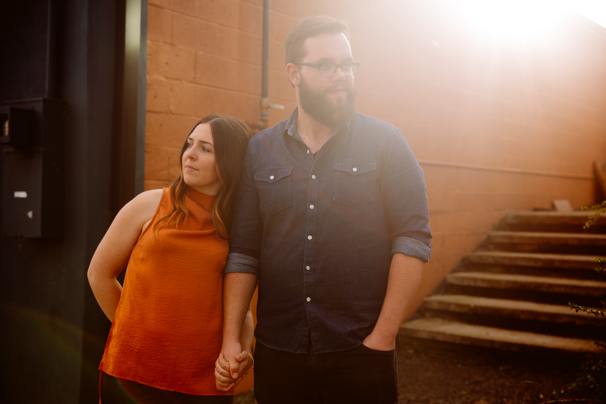 Two black-and-white photos of women giving speeches with microphones at an outdoor event. Guests sit at tables, listening and smiling under string lights, with flowers and greenery in the background. Jessica Hill Photography - Wedding Photographer - Oregon