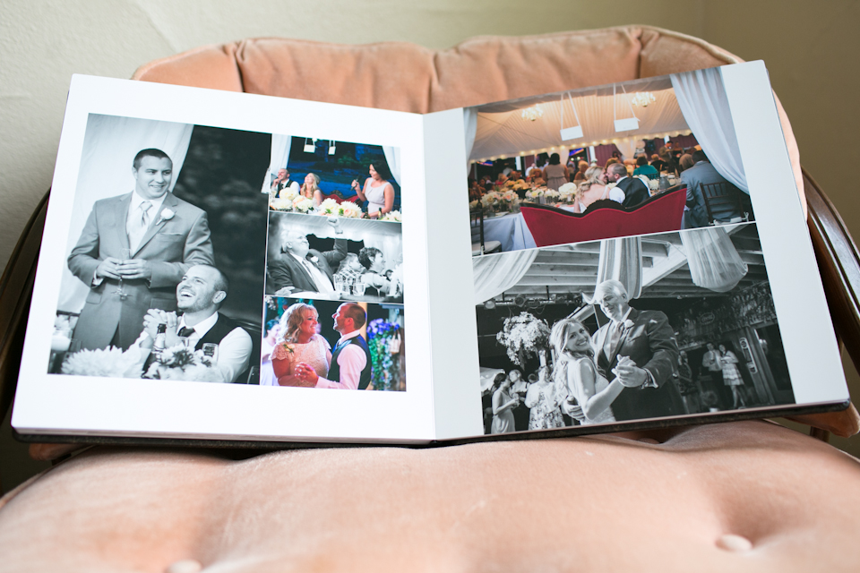 An open photo album displays a picture of a sign reading "Congratulations Justin and April." The album rests on a brown cushioned chair. Jessica Hill Photography - Wedding Photographer - Oregon