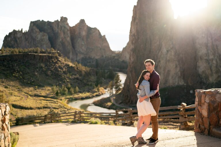 Couple hugging with rocky landscape background.