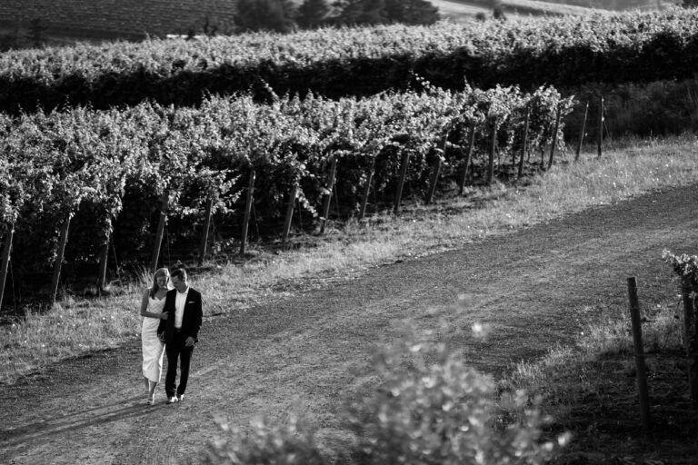 Couple walking in vineyard, black and white photo.