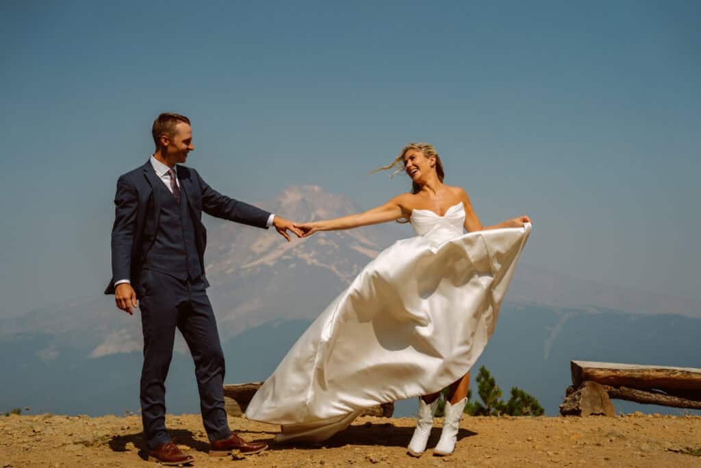 Couple dancing outdoors in wedding attire.